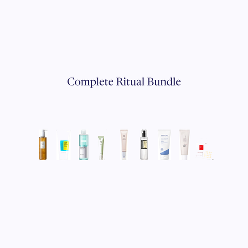 The Complete Ritual set — nine skincare products grouped on a pale ground below the Bundle's name.